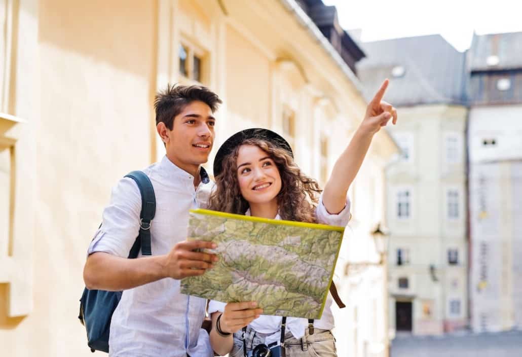 two young tourists with map and camera